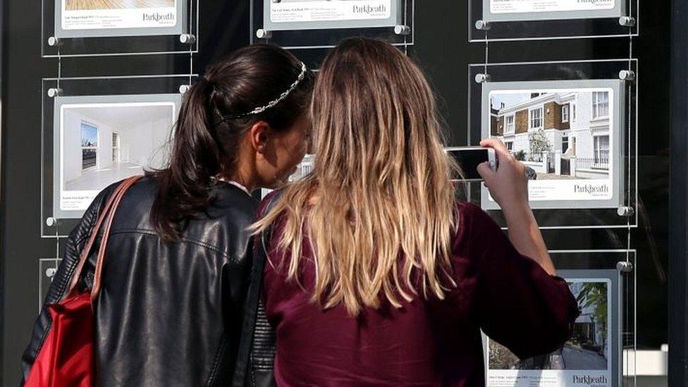 File photo of two women looking in an estate agent's window