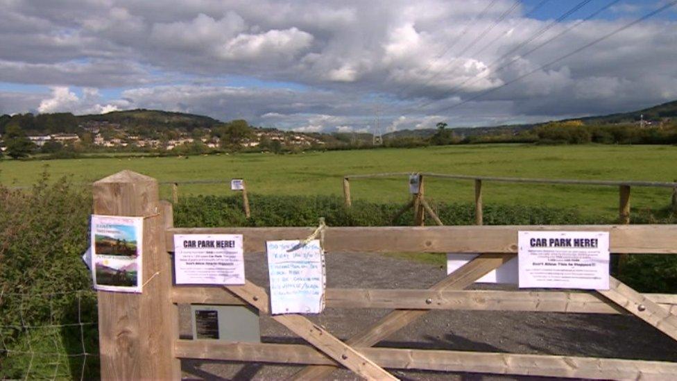 Gate into meadows with notices pinned to it about the proposed park and ride scheme