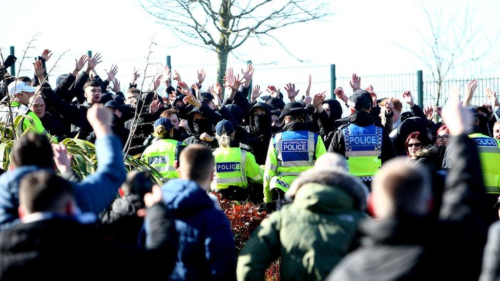 Police gather outside the stadium prior to the match