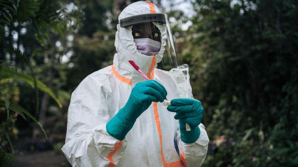 A staff member of the Congolese Ministry of Health prepares the sampling equipment to perform a COVID-19 test at a private residence in Goma, northeastern Democratic Republic of Congo, on March 31, 2020