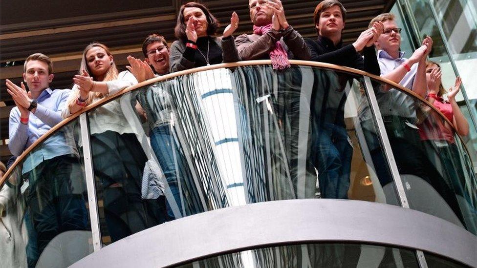 German Social Democrat party members applaud as the result of a vote approving a new coalition with Angela Merkel is announced, 4 March 2018