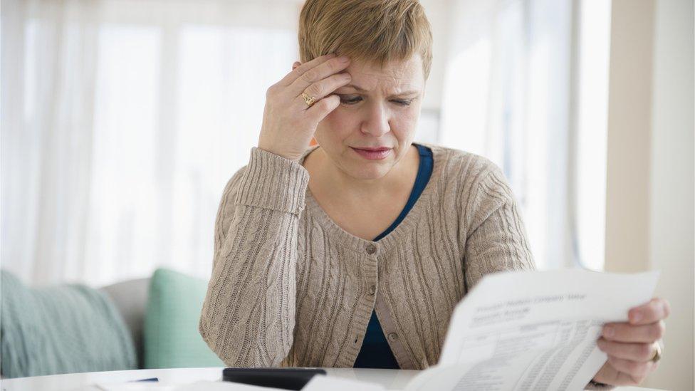 Woman looking worried over bill