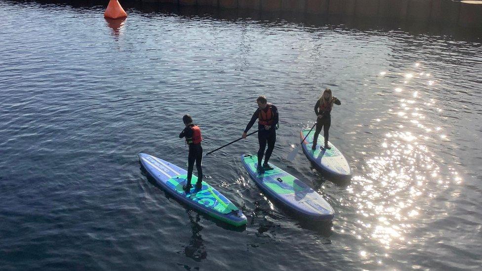 Students paddleboarding