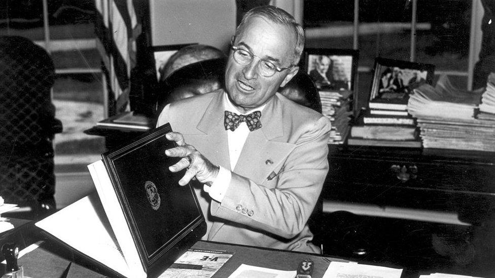 The 33rd President of the United States Harry S Truman (1884 - 1972) examining the United Nations Charter in Washington