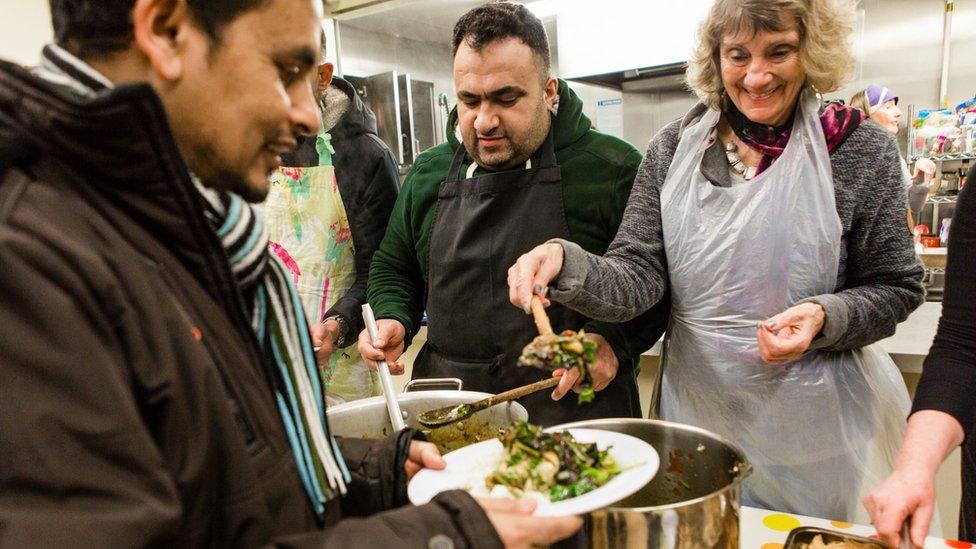 People hand out food at Borderlands' drop-in centre