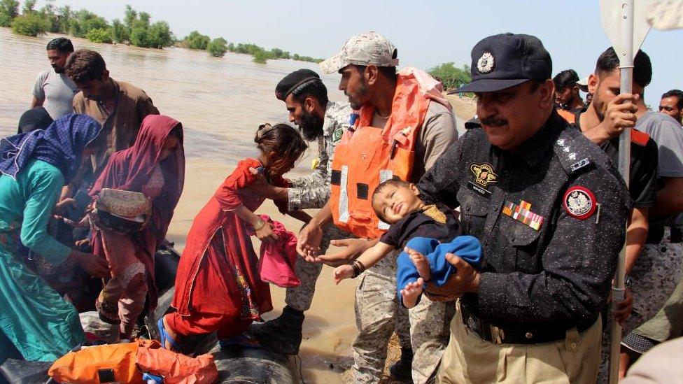 Pakistan Navy soldiers rescue people from a flooded area in Dadu District, Farid Abad Sindh province, Pakistan, 27 August 2022.