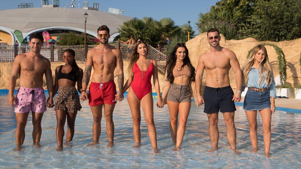 Frankie, Samira, Adam, Zara, Rosie, Alex Miller and Haley from Love Island, ankle-deep in water at Thorpe Park