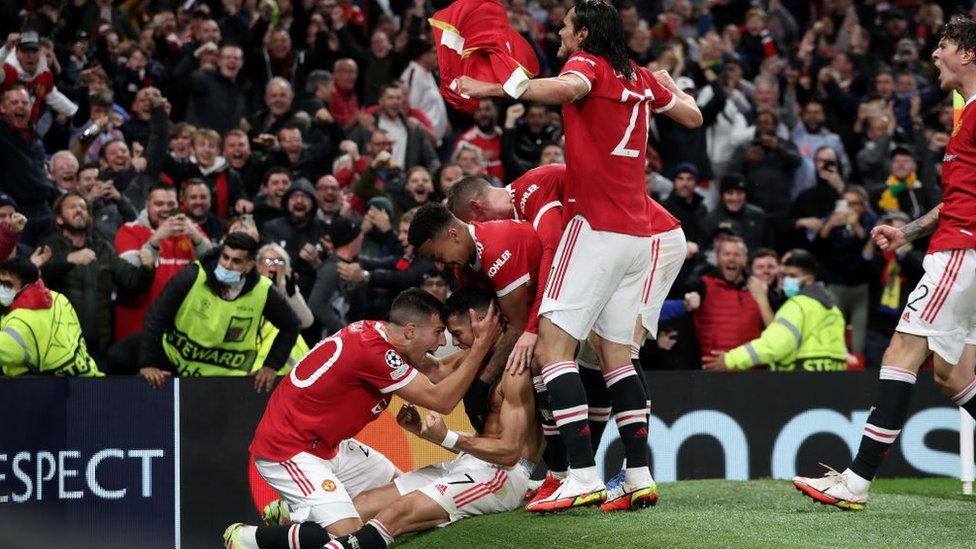 Ronaldo celebrates with his teammates after scoring the winner.