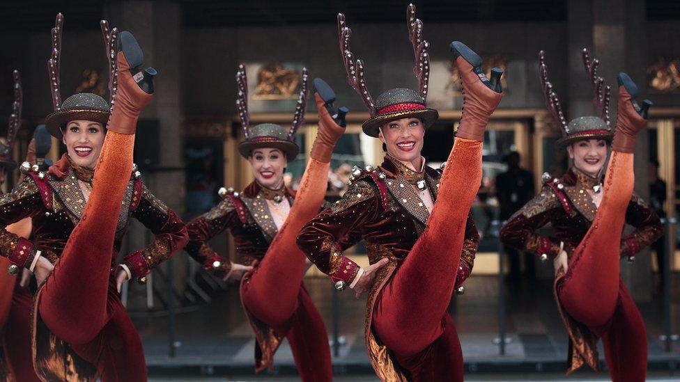 Members of The Radio City Rockettes perform during their annual Christmas in August event outside of Radio City Music Hall on 6th Avenue, New York City, 23 August 2016