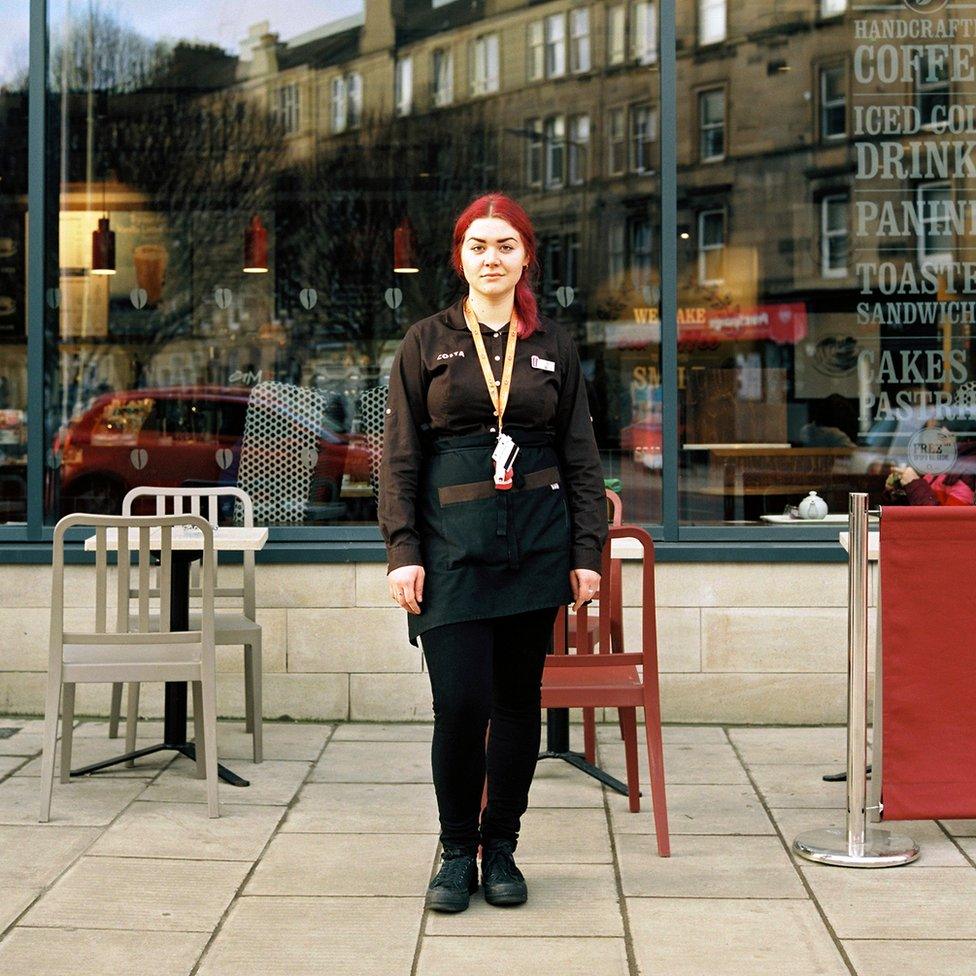 Barista outside a coffee shop