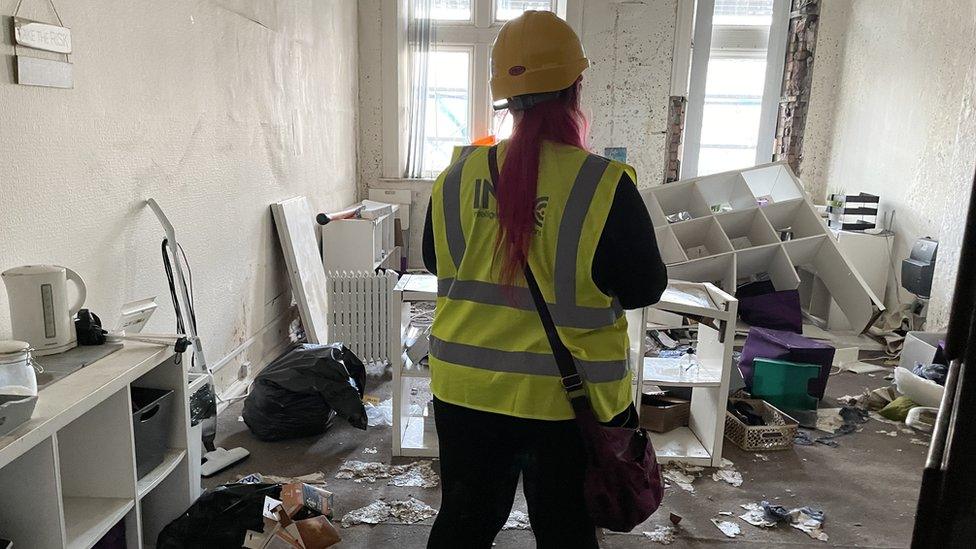 Tina Calder stands in one of her offices damaged by the fire