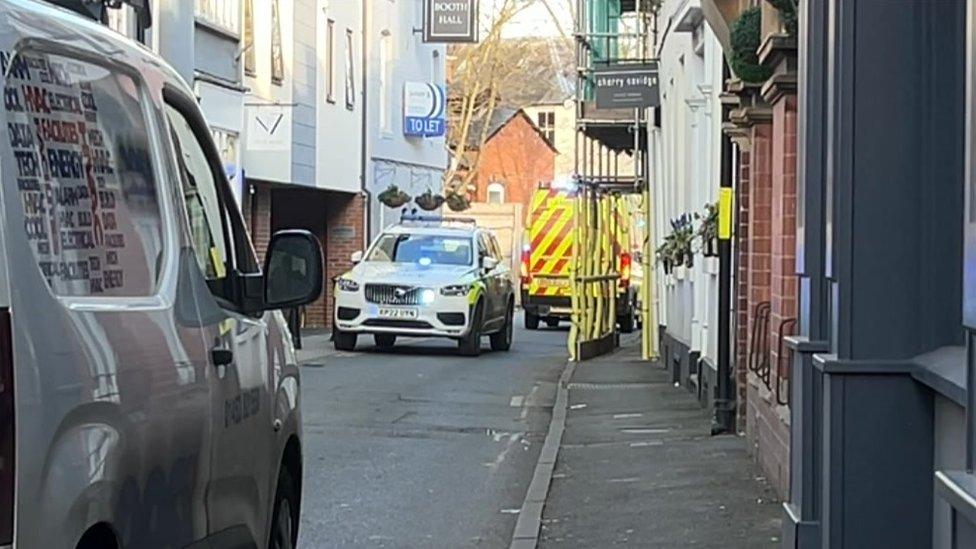 Police vehicle and scaffolding on a street