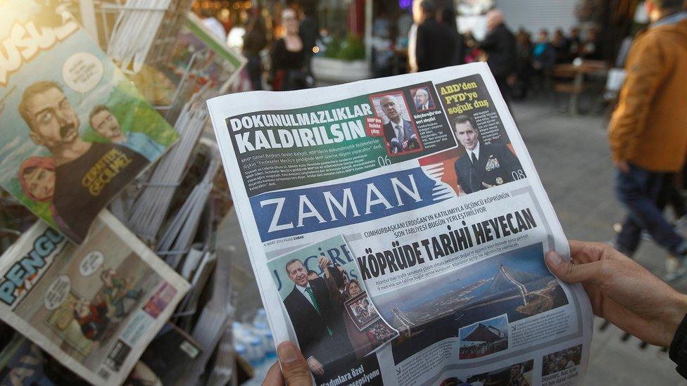 Man reads newspaper Zaman, which has been taken by the Turkish government