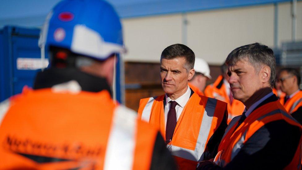 Transport Secretary Mark Harper (centre) and Vadym Prystaiko, Ukraine Ambassador to the UK, talk to a Ukrainian engineer