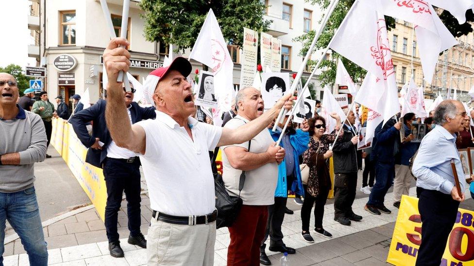 Mujahedin-e Khalq supporters protest outside the Stockholm District Court at the start of Hamid Nouri's trial (10 August 2021)