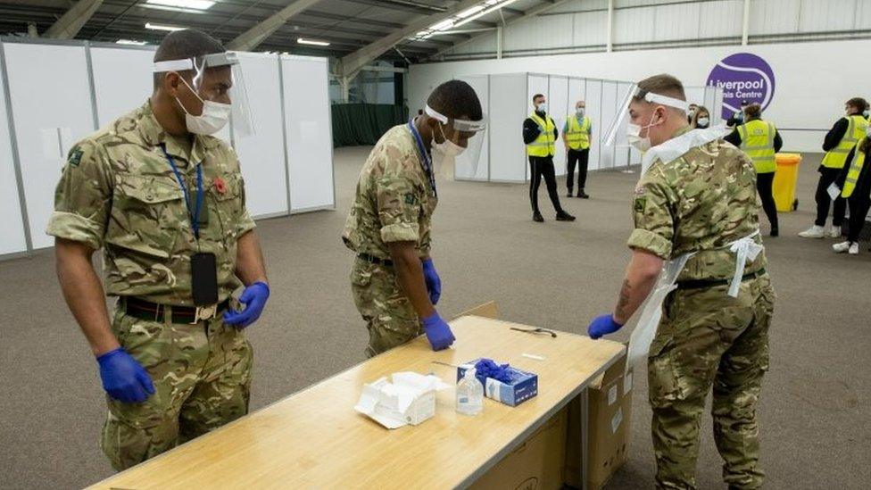 British Army soldiers conduct a COVID-19 test as part of operation moonshot in Wavertree Tennis centre