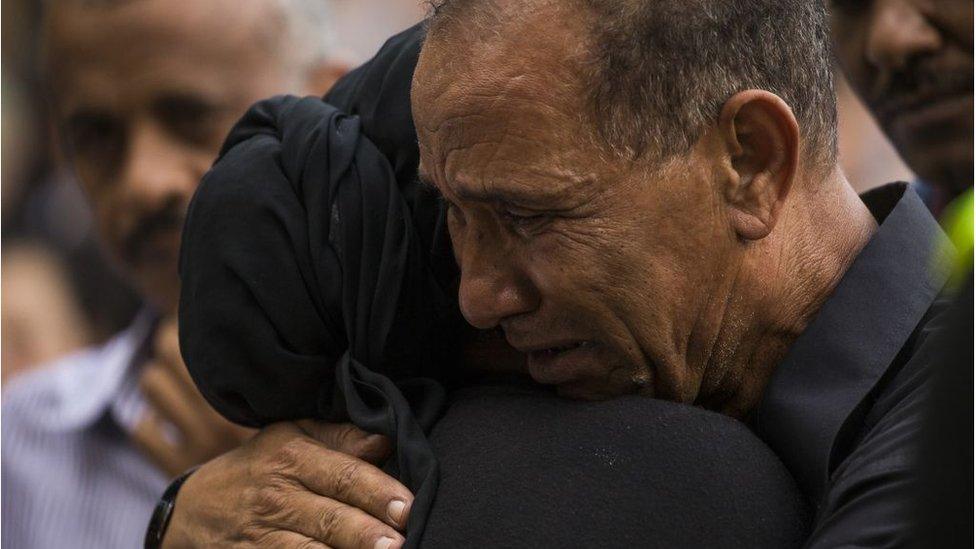 Mahmoud Hassanen embraces a family member during the vigil at Lake Anne Plaza for his daughter Nabra Hassanen