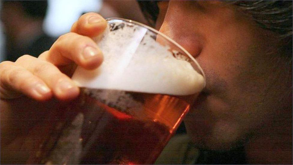 Man drinking pint