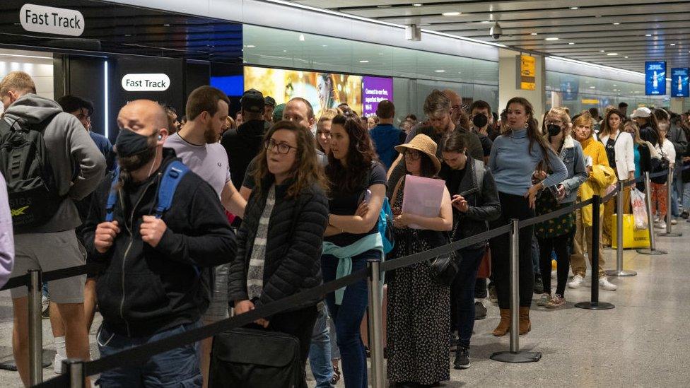 A queue of passengers at Heathrow Airport