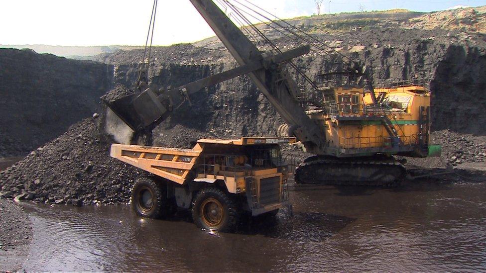 A crane working an open cast mine in India