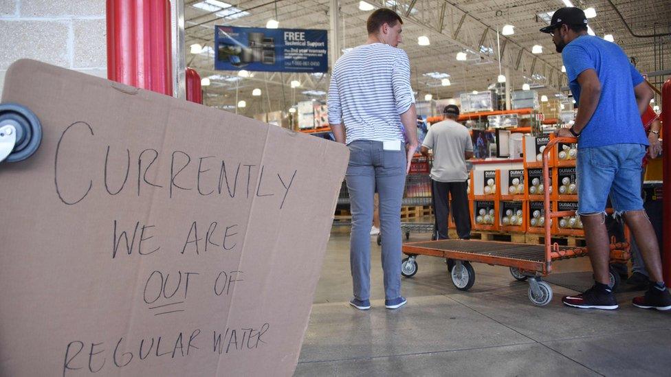 In a Florida a store sign reads: "Currently we are out of water", 6 Sept 2017