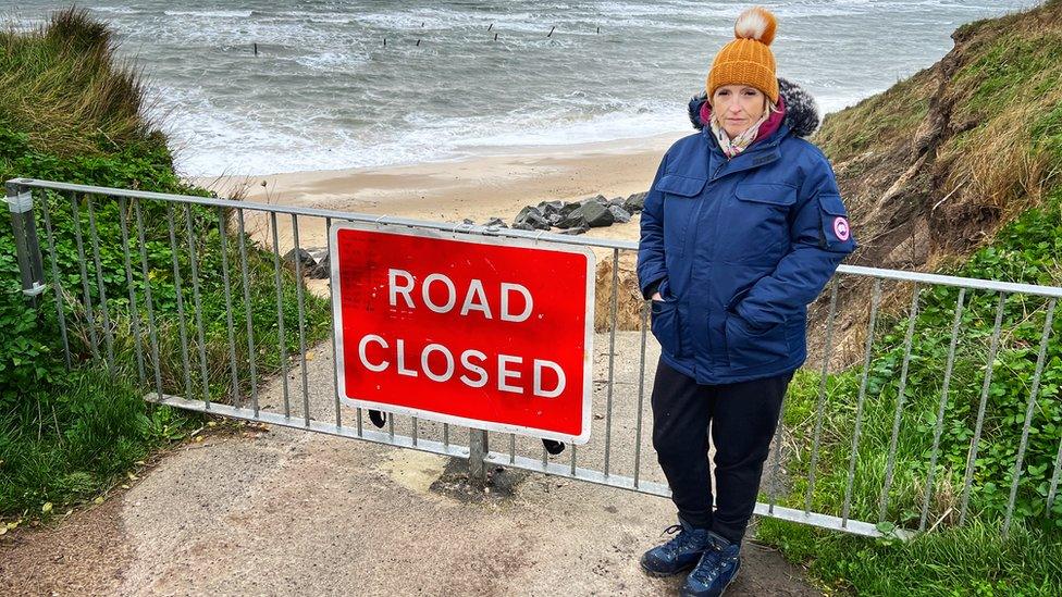 Nicola by the road closed sign