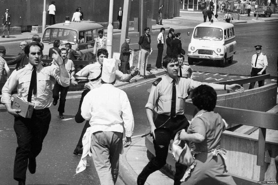 Staff at the scene of a car bomb alert at London Airport, Heathrow, 1974