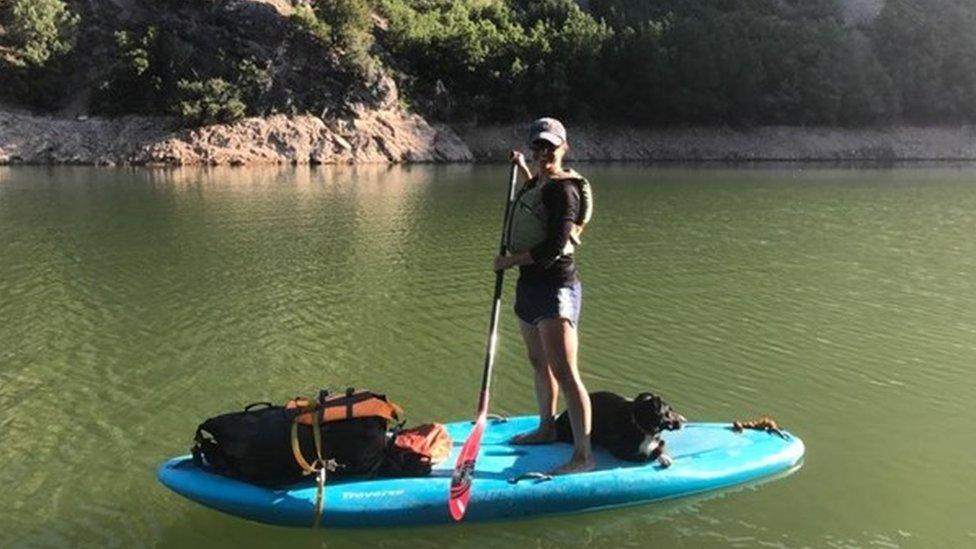 Dr Julie Young and her dog go paddle boarding