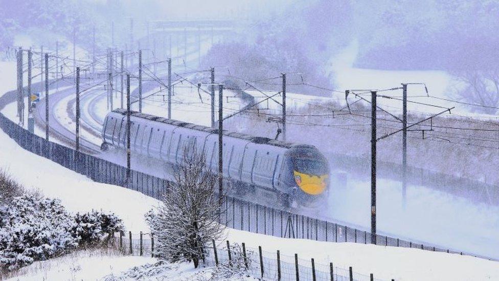 A Eurostar train passes through Ashford, Kent, following heavy overnight snowfall