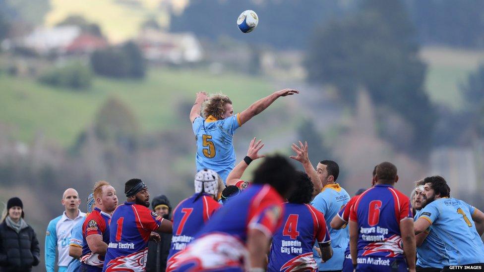 male rugby team playing a game