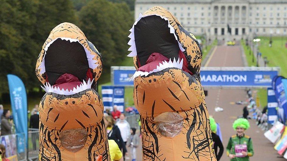 Runners dressed as dinosaurs take part in Belfast City Marathon 2021
