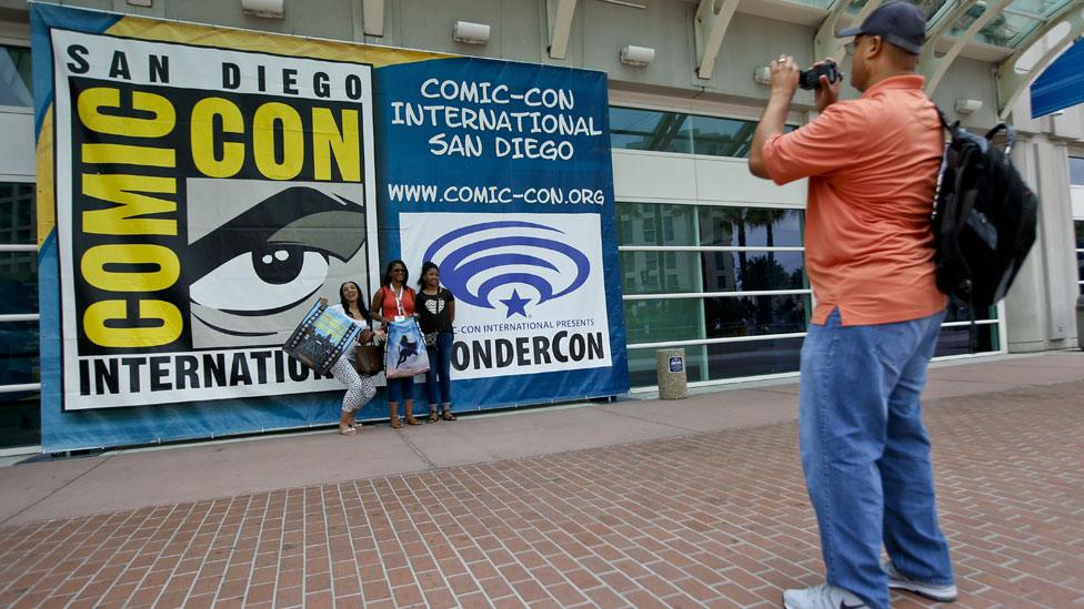 Fan taking photo outside the San Diego Convention Center