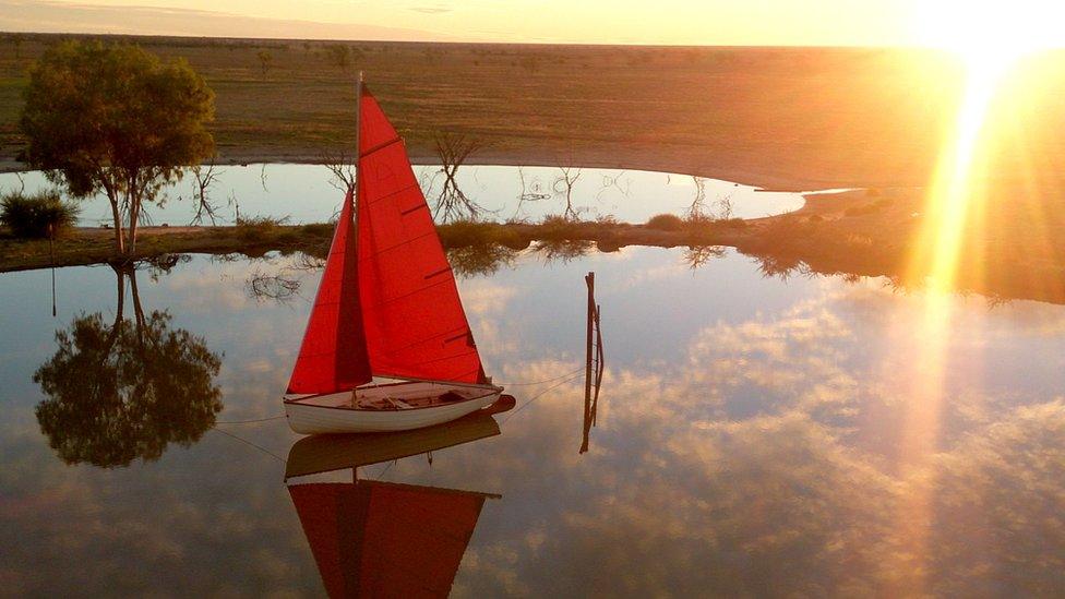 A yacht afloat on a dam at Camden Park station where the Outback Yacht Club will launch in October 2016