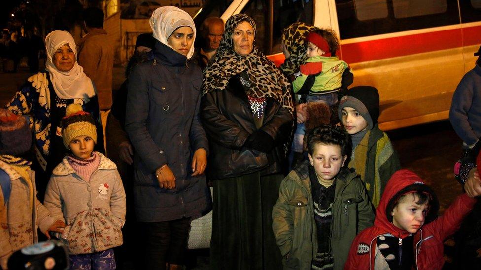 People wait to leave the besieged town of Madaya, Syria (11 January 2016)