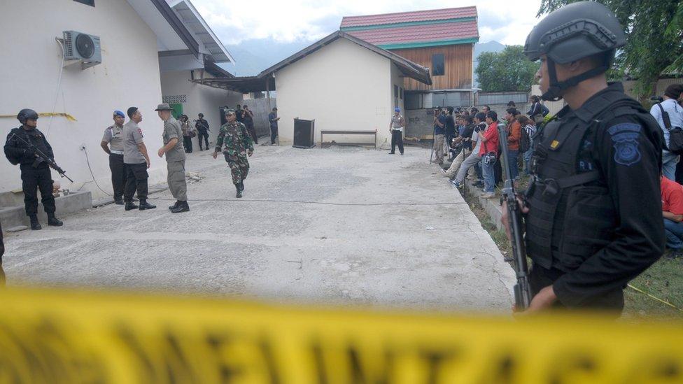 Indonesian police stand guard at a local hospital in Palu, Central Sulawesi province, on July 19, 2016, after a firefight between suspected Muslim extremists and security forces in the nearby village of Tambarana the day before