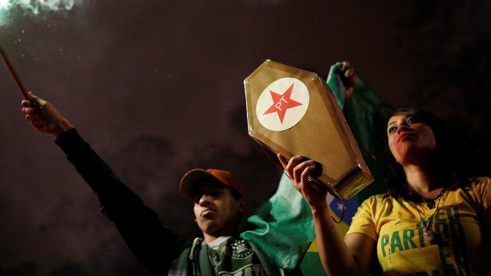 Supporters of Jair Boisonaro hold a coffin representing the death of the Workers' Party