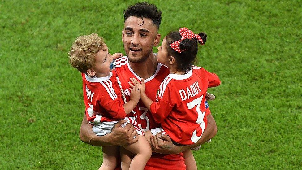 Wales' defender Neil Taylor celebrates with his children Madison and Marley at the end of the Euro 2016 quarter-final football match between Wales and Belgium