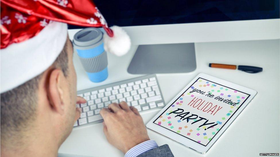 Man at his desk with party invite