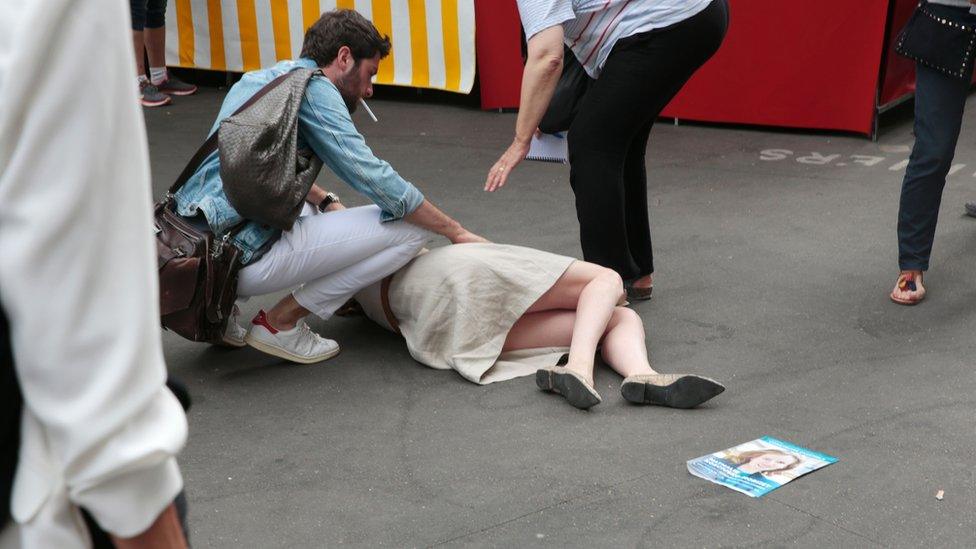 Nathalie Kosciusko-Morizet on the ground, and a man stopped over her