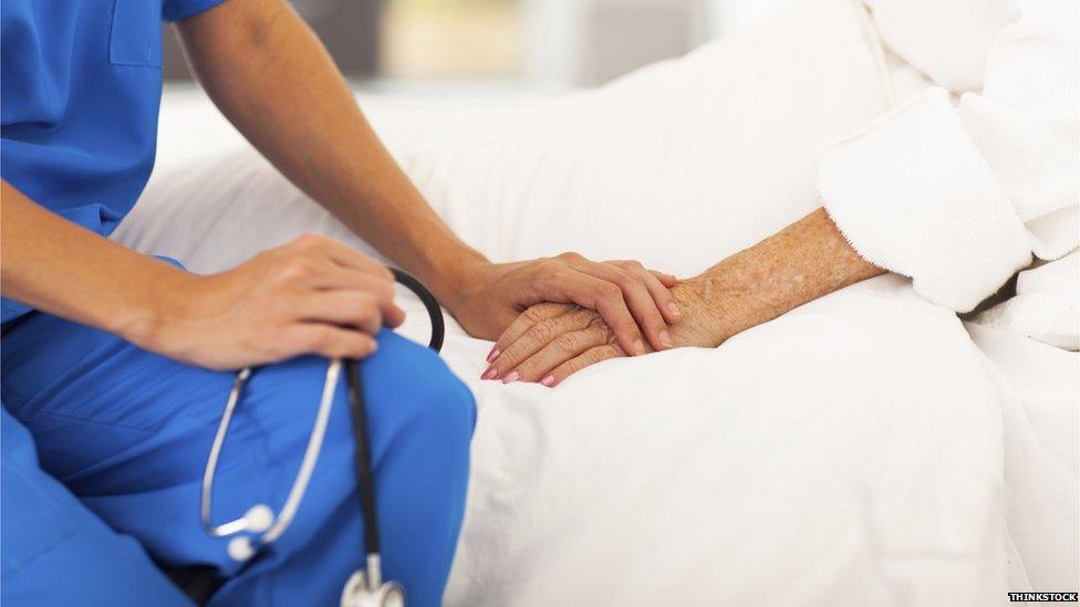 Doctor comforts patient on bed