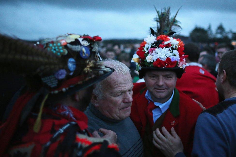 The Haxey Fool, Dale Smith (L, face not visible) and Chief Boggin Phil Palmer (R) and villagers prepare to start the Haxey Hood Game