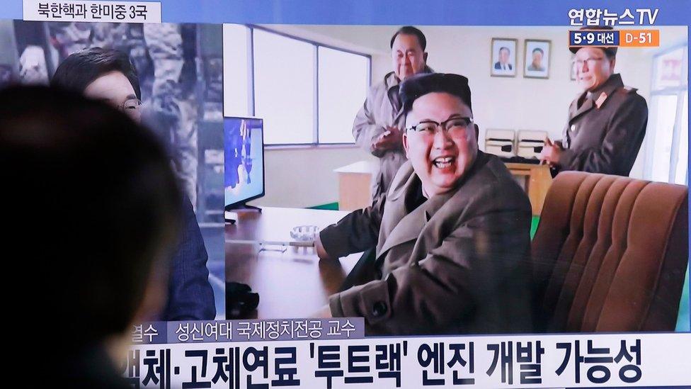 A man watches a TV news program showing an image, published in North Korea"s Rodong Sinmun newspaper, of North Korean leader Kim Jong Un at the country"s Sohae launch site, at Seoul Railway station in Seoul, South Korea, Sunday, March 19, 2017