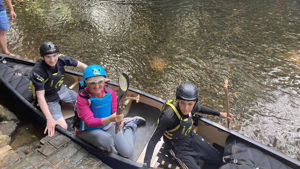 Baton-bearer in canoe