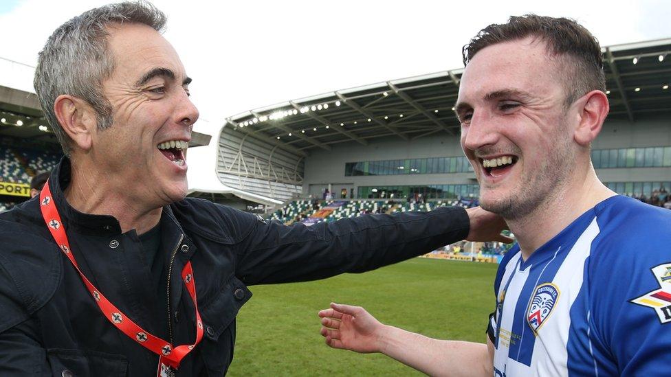 Coleraine's most famous fan, actor Jimmy Nesbitt, celebrates with team skipper Stephen O'Donnell after the final whistle