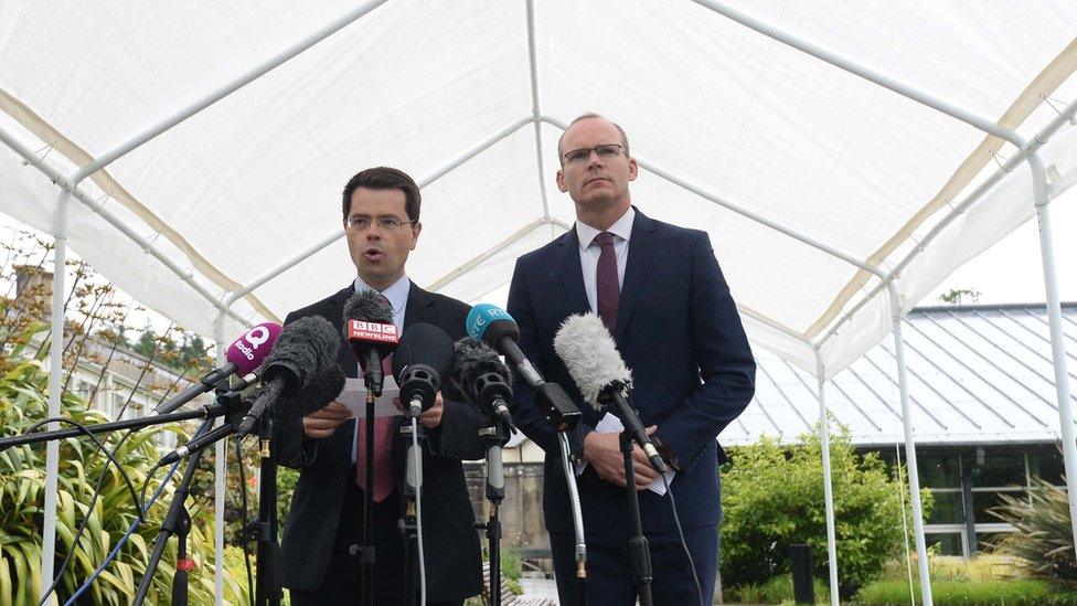 NI Secretary James Brokenshire and Irish Foreign Minister Simon Coveney speaking at a press tent at Stormont castle