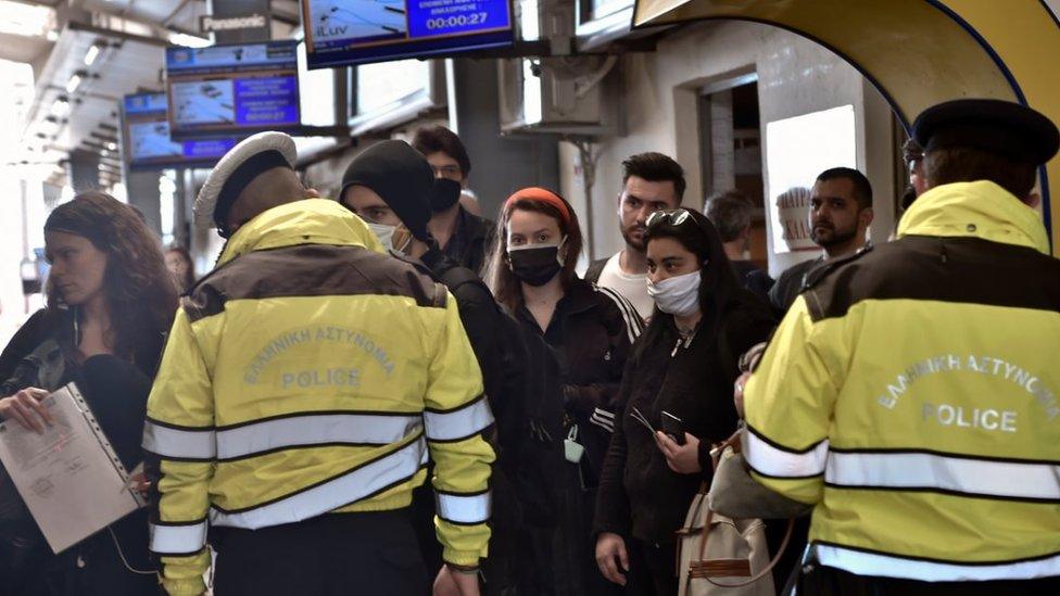 A policeman, wearing a face mask for protect from coronavirus, check documents verifying purpose of movement during the coronavirus disease (COVID-19) outbreak on 17 April