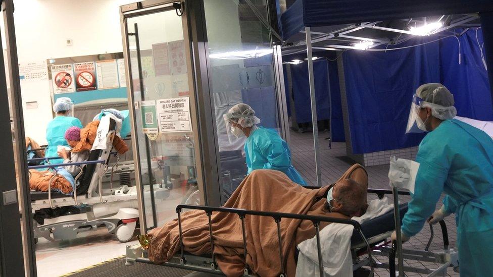 Medical workers move patients inside a hospital