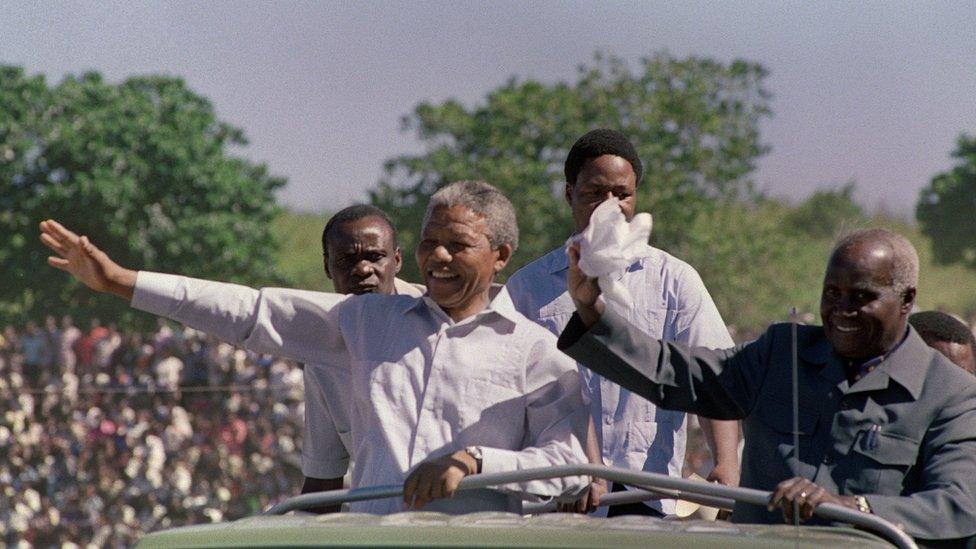 3 March 199: South African anti-apartheid leader and African National Congress (ANC) member Nelson Mandela (L) and Zambian President Kenneth Kaunda (R) wave to the crowd as they arrive at a mass rally in Lusaka