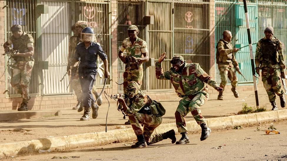 A soldier fires shots towards demonstrators as protests erupted over alleged fraud in the country's election, Harare, Zimbabwe - 1 August 2018