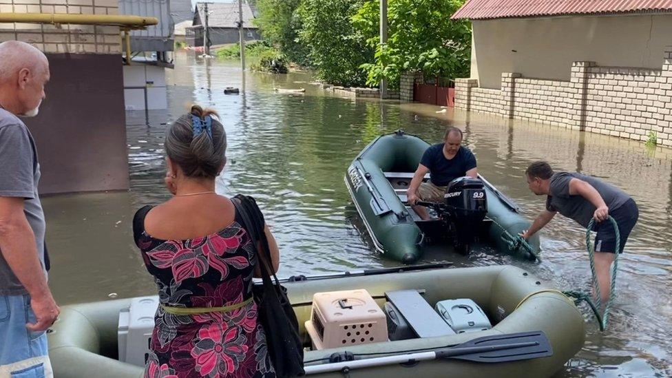 Kherson residents in flooded street